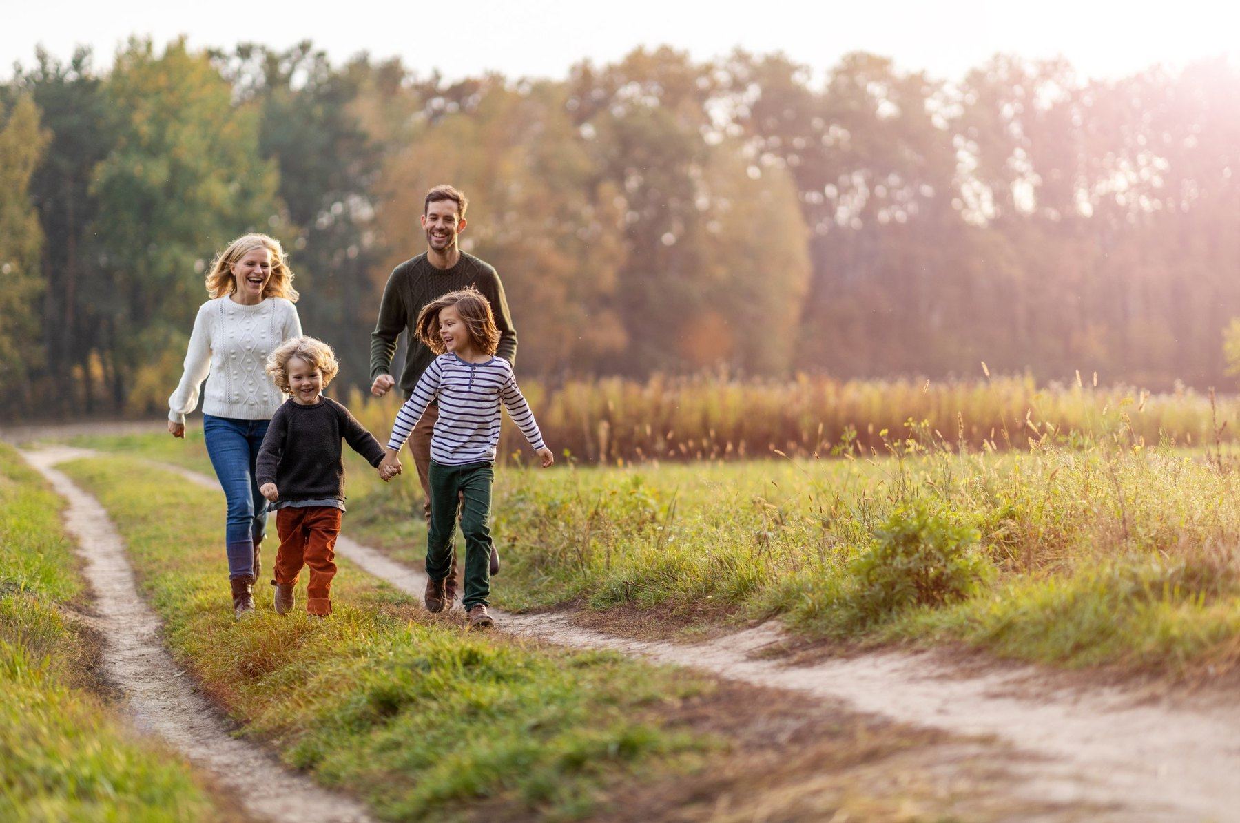 A family walking together down a sunlit country path